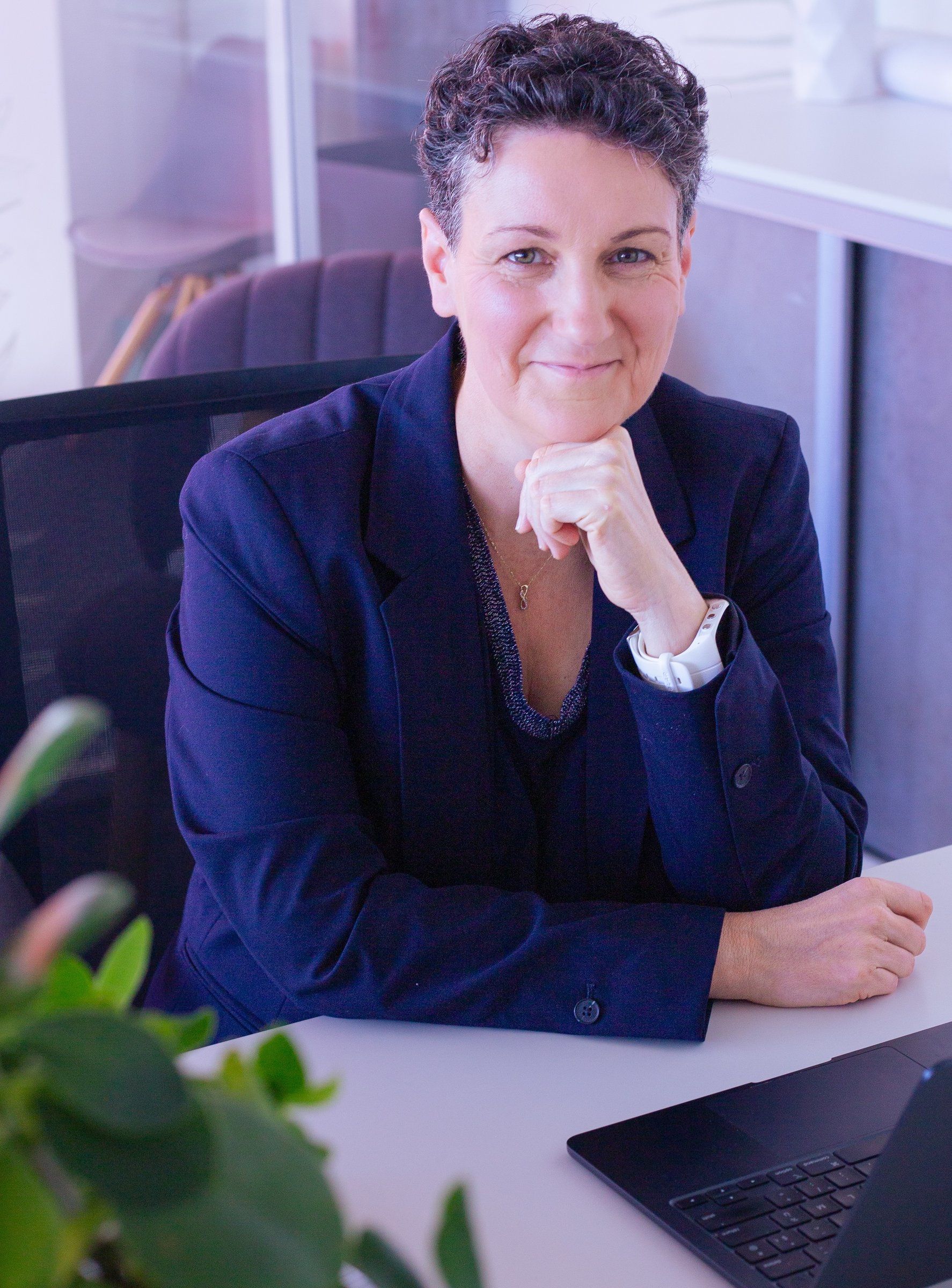 Portrait de Marie-Laure Bourgeois, fondatrice de Plume Digitale, souriante à son bureau